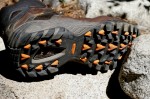 Orange shark-teeth shaped cleats on the Fortis outsole are slightly raised above black tread blocks to offer superior traction on any terrain surface.