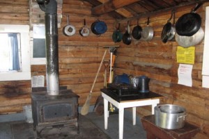 stove Interior of Hogan Cabin with wood stove and basic cooking hardware.